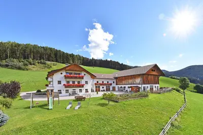 a large white building in a green field at Fuchshof in Perca