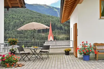a patio with a table and chairs and a boat at Fuchshof in Perca