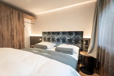 a living room with a wooden table and chairs at Villa A - NEW OPENING in Selva di Val Gardena