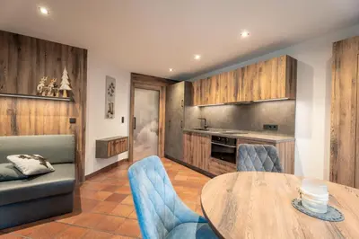 a kitchen and dining room with a table and chairs at Villa A - NEW OPENING in Selva di Val Gardena