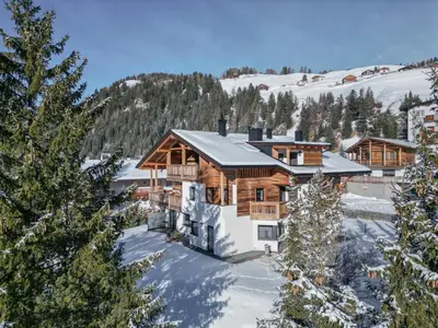 a town in the mountains with trees at Villa A - NEW OPENING in Selva di Val Gardena