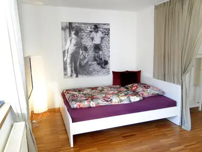 a bedroom with a bed and a painting on the wall at Gemütliches Studio mit Parkgarage in Naturno
