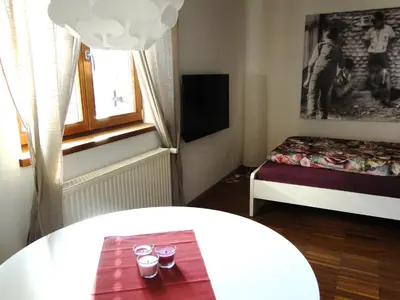a small room with a bed and a table with glasses at Gemütliches Studio mit Parkgarage in Naturno