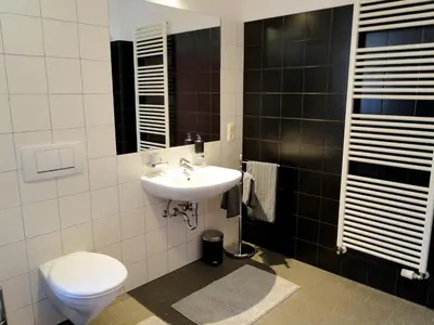 a bathroom with a sink and a toilet at Gemütliches Studio mit Parkgarage in Naturno
