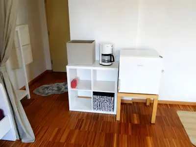 a room with a white refrigerator and a coffee maker at Gemütliches Studio mit Parkgarage in Naturno
