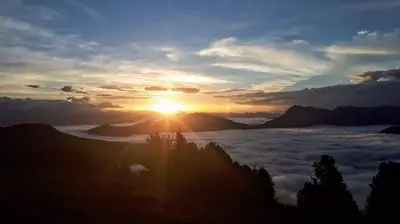a view of the sun rising above the clouds at Canalhof in Antermoia
