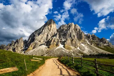 a dirt road in front of a mountain at Canalhof in Antermoia