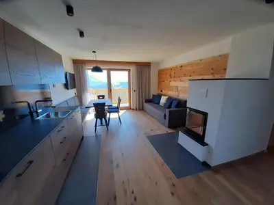 a kitchen and living room with a couch and a table at Canalhof in Antermoia