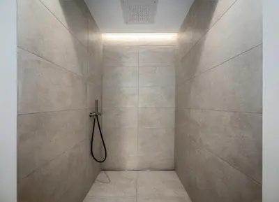 a bathroom with a shower with a hose at Anna Lodges Dolomites in Santa Cristina in Val Gardena