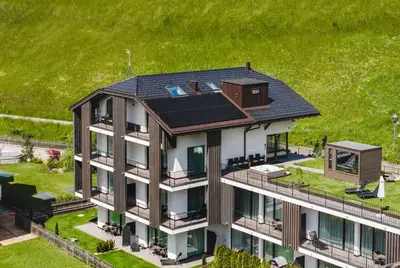 an aerial view of a house with a solar roof at Anna Lodges Dolomites in Santa Cristina in Val Gardena