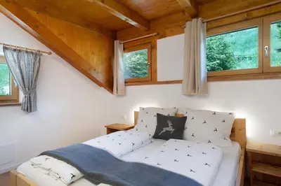 a white couch in a room with windows at Unterurban DIE EINS in Unsere Liebe Frau im Walde