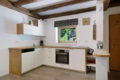 a kitchen with white cabinets and a window at Unterurban DIE EINS in Unsere Liebe Frau im Walde