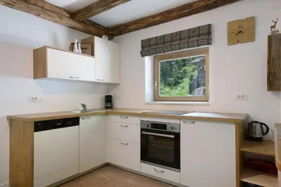 a kitchen with white cabinets and a window at Unterurban DIE EINS in Unsere Liebe Frau im Walde