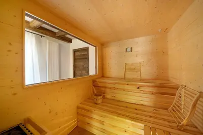 a wooden sauna with a window and a chair at Unterurban DIE EINS in Unsere Liebe Frau im Walde