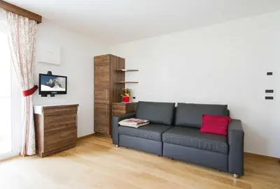 a living room with a couch and a table at Apartment Romana in Selva di Val Gardena
