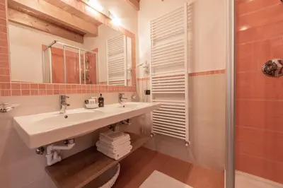 a bathroom with a sink and a shower at Les Gomines BB***** in San Vigilio Di Marebbe