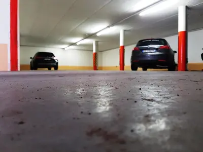 two cars parked in an empty parking garage at Les Gomines BB***** in San Vigilio Di Marebbe