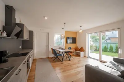 a living room with a couch and a table at T-Collection Premium Apartments in Vipiteno
