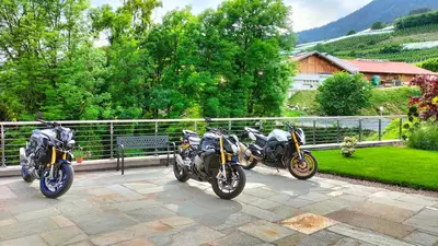 two motorcycles parked next to each other on a patio at Agritur La Fenice in Brez