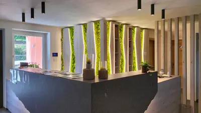 a lobby with green walls and a table with candles at Agritur La Fenice in Brez