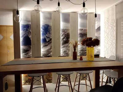a dining room table with a view of a mountain at Agritur La Fenice in Brez