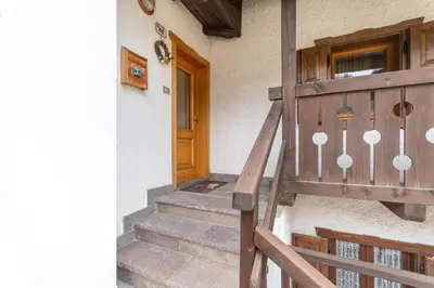 a staircase leading to a door of a house at Casa Morel in Falcade