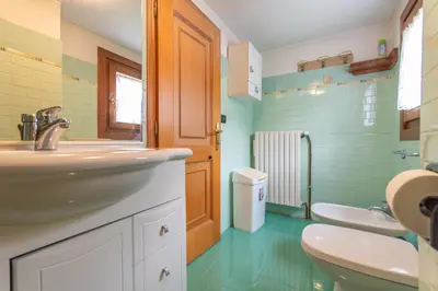 a bathroom with two sinks and two toilets at Casa Morel in Falcade
