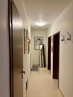 a hallway with a refrigerator in a room at Pragma Apartments - Appartamento Dellantonio in Predazzo