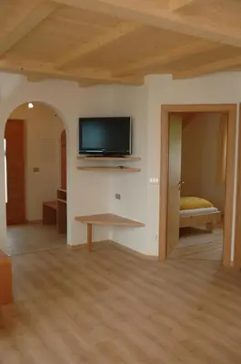 a living room with a flat screen tv on a wall at Lavendelhof in Appiano sulla Strada del Vino