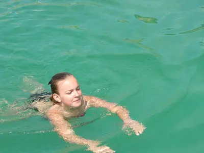 a woman swimming in the water with a whale shark at Lavendelhof in Appiano sulla Strada del Vino