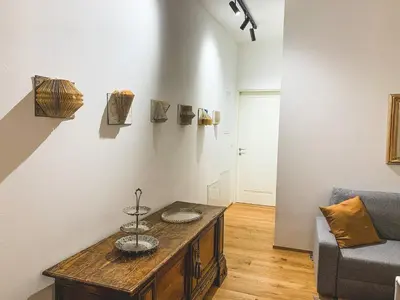 a living room with a table and a couch at Palais Carducci in Bolzano