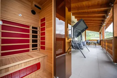 a room with a balcony with a flat screen tv at Appartement Schusterhof in Gries