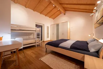 a bedroom with a bed and a desk and a table at Appartement Schusterhof in Gries