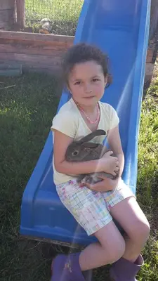 a little girl is sitting on a slide at Tinnerhof in Appiano sulla Strada del Vino