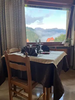 a group of buildings with mountains in the background at Hotel Cime d'Auta in Falcade