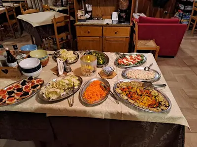 a white plate with different types of food on it at Hotel Cime d'Auta in Falcade