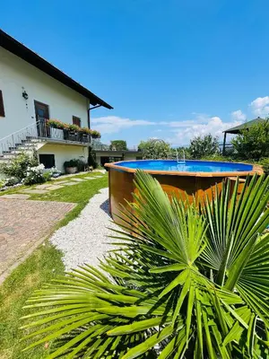 a house with a blue swimming pool next to a palm tree at Wiesenheim- Unterer Plattenhof 
