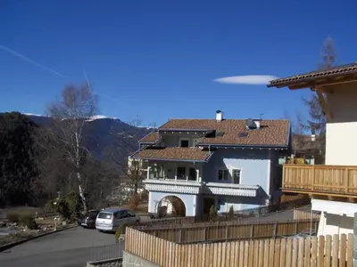 a frisbee flying over a house with a fence at villa mahlfertheiner in Castelrotto