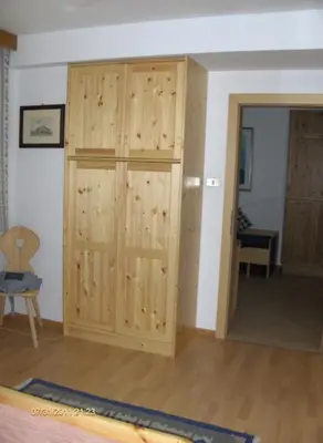 a room with a wooden closet in a room at villa mahlfertheiner in Castelrotto