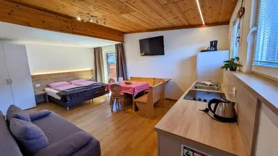 a living room with a couch and a table at Appartements Tirol in San Lorenzo di Sebato