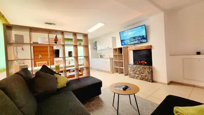 a living room with a couch and a fireplace at Appartements Tirol in San Lorenzo di Sebato