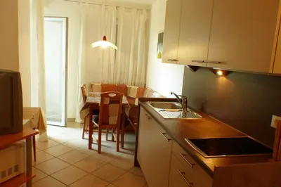 a kitchen with a table and a dining room at Residence Liesy in Tesimo