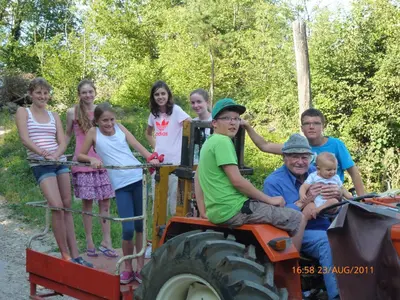 a group of people sitting on the back of a tractor at Residence Liesy in Tesimo