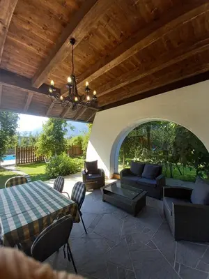 a patio with a couch and a table and chairs at Mittelbergerhof Ferienwohnungen in Vilpiano