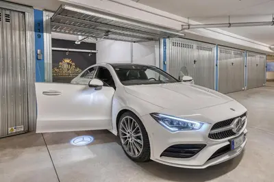 a white car parked in a garage at City Café - CENTRAL Apartment in Brunico