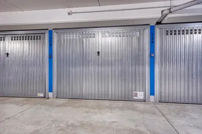 a row of metal garage doors in a building at City Café - CENTRAL Apartment in Brunico
