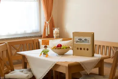 a table with a bowl of fruit and a toy on it at Gutshof Sinn in Caldaro