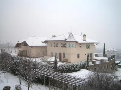 a house with snow on the roof at Gutshof Sinn in Caldaro