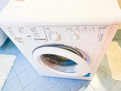 a washing machine in a box on a floor at Cozy city center apartment in Bolzano
