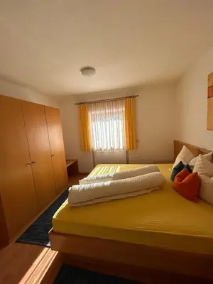 a bedroom with two beds and a window at Appartements Schatzer in Valdaora